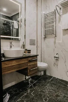 a white bathroom with a sink and a toilet at Otel Grand Lark İstanbul in Istanbul