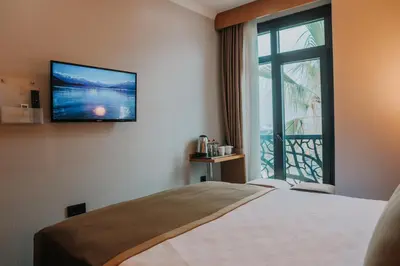 a hotel room with a bed and a large window at Otel Grand Lark İstanbul in Istanbul