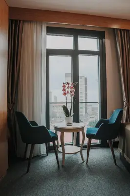 a room with a table and two chairs and a window at Otel Grand Lark İstanbul in Istanbul
