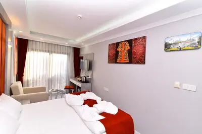 a hotel room with a bed and a chair at Little sofia hotel in Istanbul
