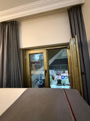 a bedroom with a bed and a window with curtains at RHYTHM HOTEL in Istanbul