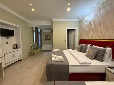 a bedroom with a large bed with a red headboard at RHYTHM HOTEL in Istanbul