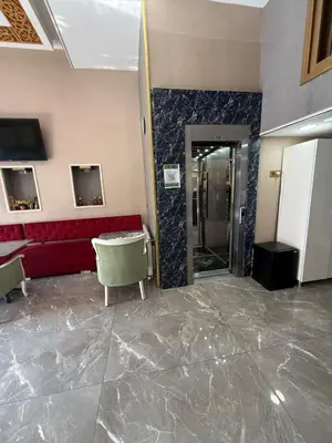 a lobby with a red couch and a elevator at RHYTHM HOTEL in Istanbul