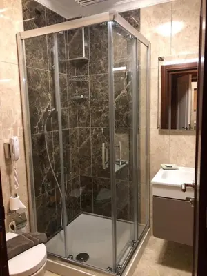 a bathroom with a shower with a toilet and a sink at Blue Pier Hotel in Kocaeli
