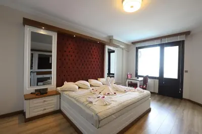 a bedroom with a large bed and a large window at Blue Pier Hotel in Kocaeli