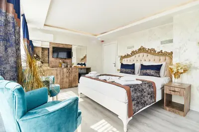 a bedroom with a bed and a blue chair at Armar Hotel in Istanbul