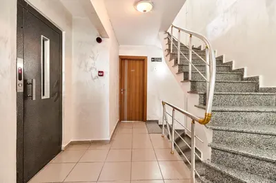 a hallway with stairs and a wooden door at Armar Hotel in Istanbul