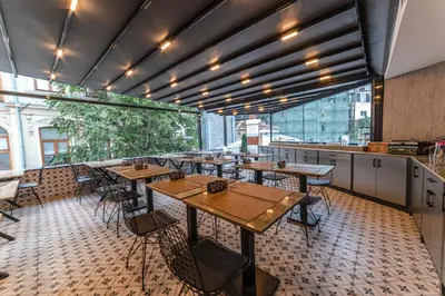 an empty restaurant with wooden tables and chairs at World Heritage Center Hotel in Istanbul