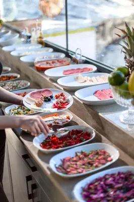 a buffet line of plates of food on a table at World Heritage Center Hotel in Istanbul