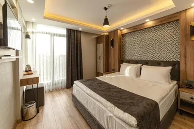 a bedroom with a large bed and a large window at World Heritage Center Hotel in Istanbul