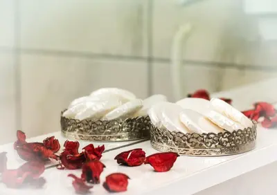 two cakes on a white shelf with red roses at Zeyn Otel Istanbul in Istanbul