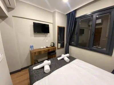 a bedroom with a bed with white towels on it at Zeyn Otel Istanbul in Istanbul