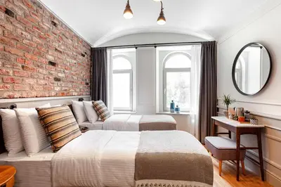 a bedroom with two beds and a brick wall at World House Boutique Hotel Galata in Istanbul