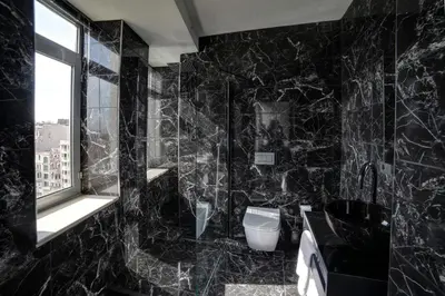 a black bathroom with a toilet and a window at Taksim Seya Suites Hotel in Istanbul