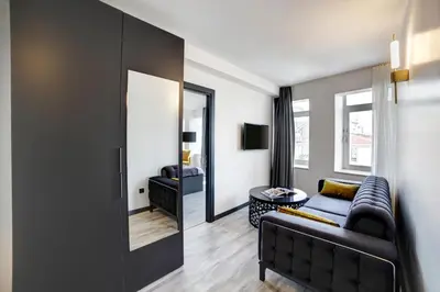 a living room with a couch and a mirror at Taksim Seya Suites Hotel in Istanbul
