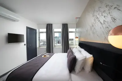 a bedroom with a large bed with white sheets and pillows at Taksim Seya Suites Hotel in Istanbul