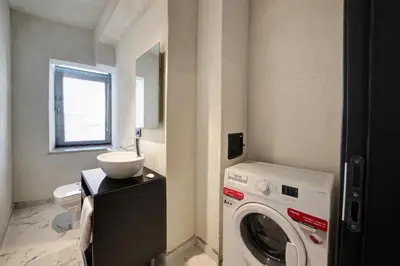 a laundry room with a washing machine and a window at Taksim Seya Suites Hotel in Istanbul