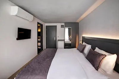 a bedroom with a large white bed in a room at Taksim Seya Suites Hotel in Istanbul