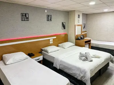 a hospital room with two beds and a tub at Avcılar İnci Hotel in Istanbul
