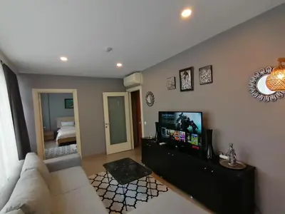 a living room with a couch and a flat screen tv at Levent Apartments in Istanbul