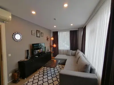 a living room with a couch and a television at Levent Apartments in Istanbul