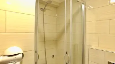 a shower with a glass door in a bathroom at NOUR SUITE & RESIDENCE in Istanbul