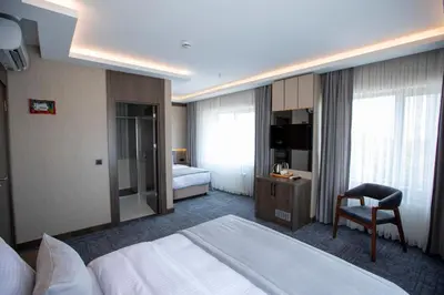 a hotel room with a bed and a chair at THE GREEN HOTEL in Istanbul
