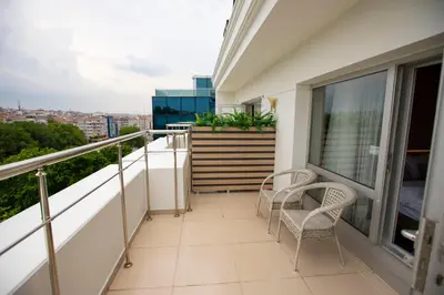a balcony with two chairs and a table at THE GREEN HOTEL in Istanbul