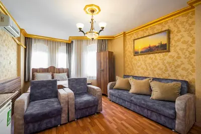 a living room with a couch and two chairs at Kervanchi in Istanbul