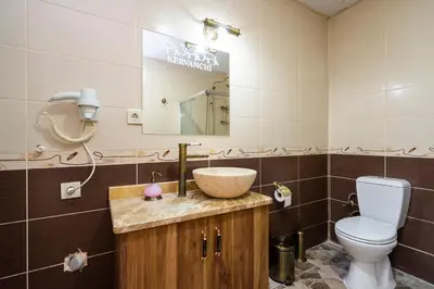 a bathroom with a sink and a toilet and a mirror at Kervanchi in Istanbul