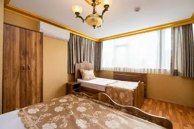 a bedroom with two beds and a chandelier at Kervanchi in Istanbul