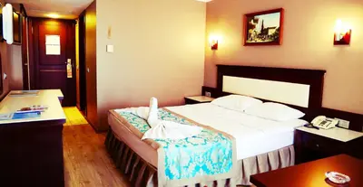 a hotel room with a bed and a telephone at Kumburgaz Blue World Hotel in Buyukcekmece