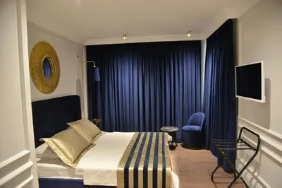 a hotel room with a bed and a blue chair at A11 HOTEL Exclusive in Istanbul