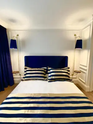 a bedroom with a blue and white bed with two pillows at A11 HOTEL Exclusive in Istanbul
