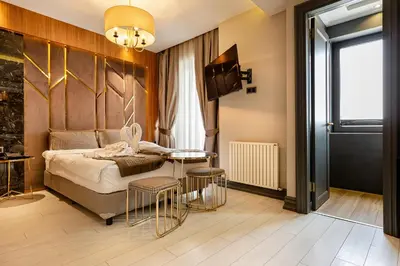a bedroom with a bed and a table and chairs at Santra Hotel in Istanbul