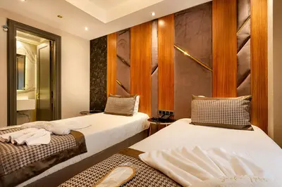 a room with two beds and a mirror at Santra Hotel in Istanbul