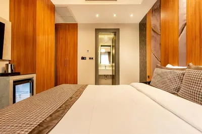 a bedroom with a white bed and a fireplace at Santra Hotel in Istanbul