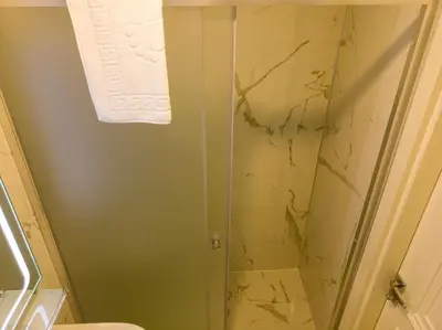 a shower with a glass door in a bathroom at Bursa Ulupark Hotel in Bursa