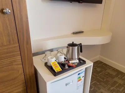 a counter with a coffee maker on top of a refrigerator at Bursa Ulupark Hotel in Bursa