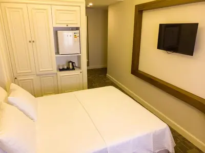 a room with a white bed and a mirror at Bursa Ulupark Hotel in Bursa