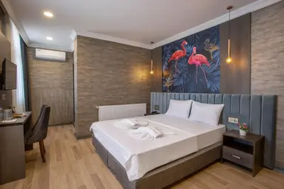 a bedroom with a bed and a painting on the wall at La Vie Suite Hotel in Istanbul