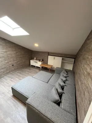 a room with a bed and a couch and a table at La Vie Suite Hotel in Istanbul