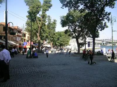 a group of people walking around a street with trees at Bosphorus Bridge in Istanbul