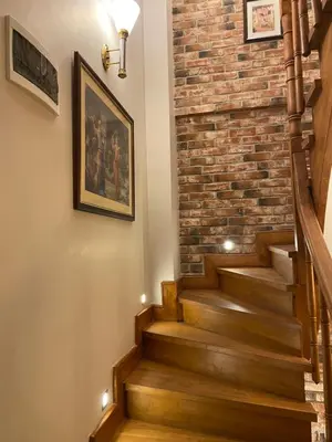 a staircase with a brick wall and wooden stairs with lights at Bosphorus Bridge in Istanbul