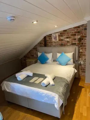 a bedroom with a large bed with blue pillows at Bosphorus Bridge in Istanbul