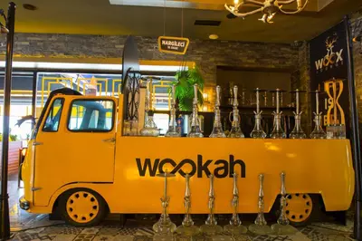 a yellow truck parked in front of a bar at Hotel BFC Spa & Sport in Bursa
