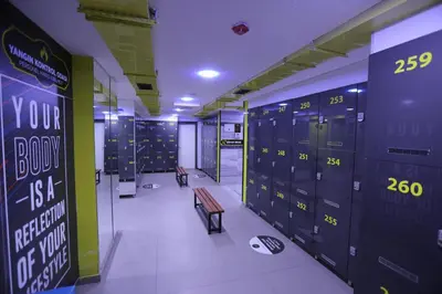 a locker room with blue lockers and a bench at Hotel BFC Spa & Sport in Bursa
