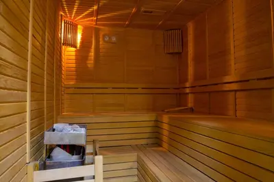 a wooden sauna with a bench in the middle at Hotel BFC Spa & Sport in Bursa