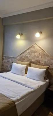 a large bed with two white pillows in a room at Royal Park Hotel Corlu Bed and Breakfast in Tekirdag