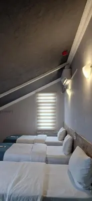 a row of beds in a room with a window at Royal Park Hotel Corlu Bed and Breakfast in Tekirdag